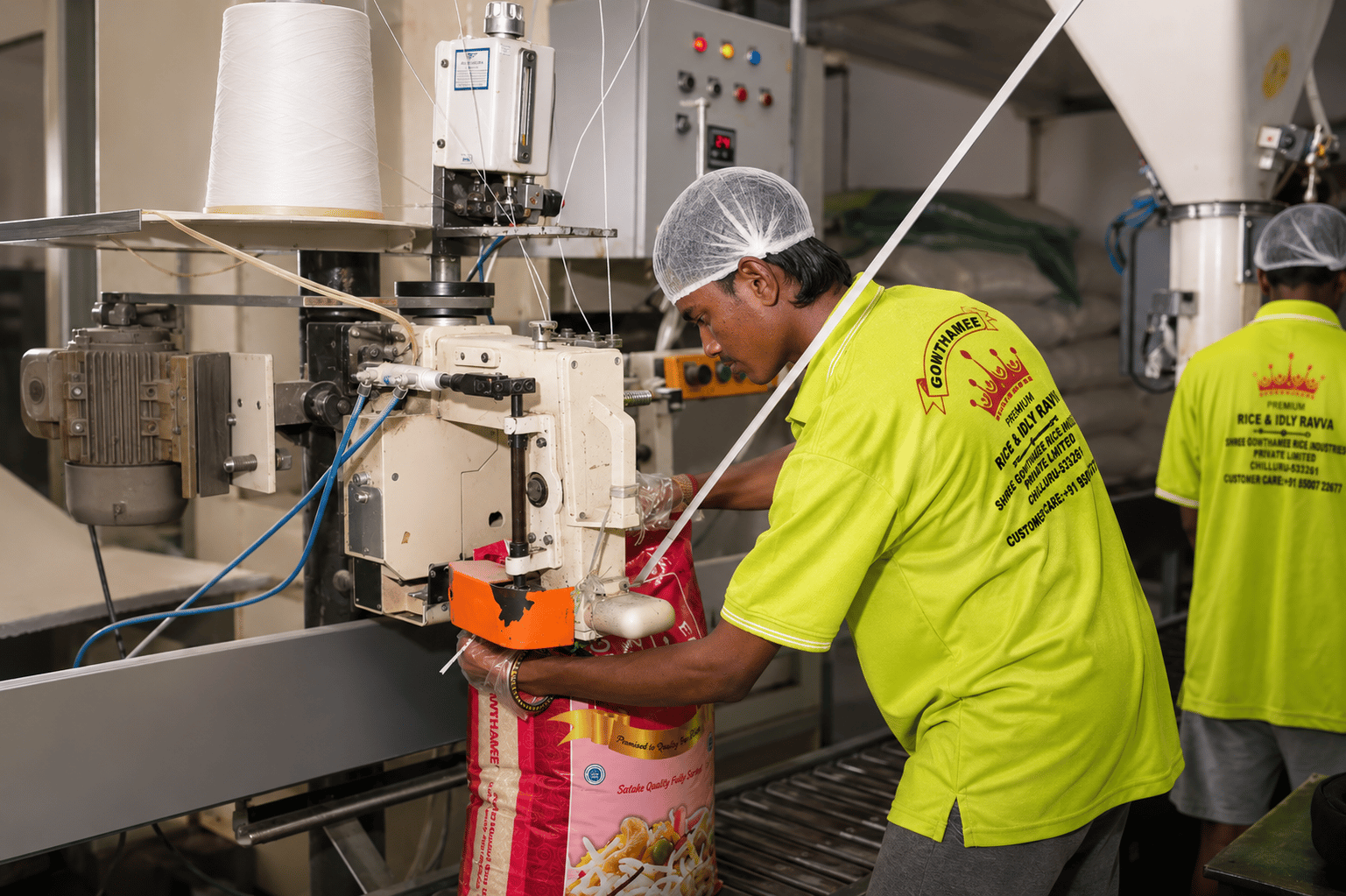 Workers stitching rice bags on the Gowthamee packing line