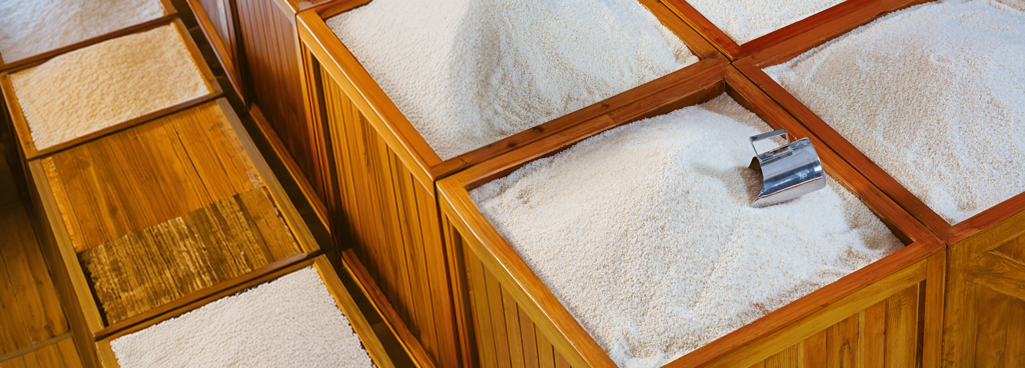 Wooden bins filled with rice and rava